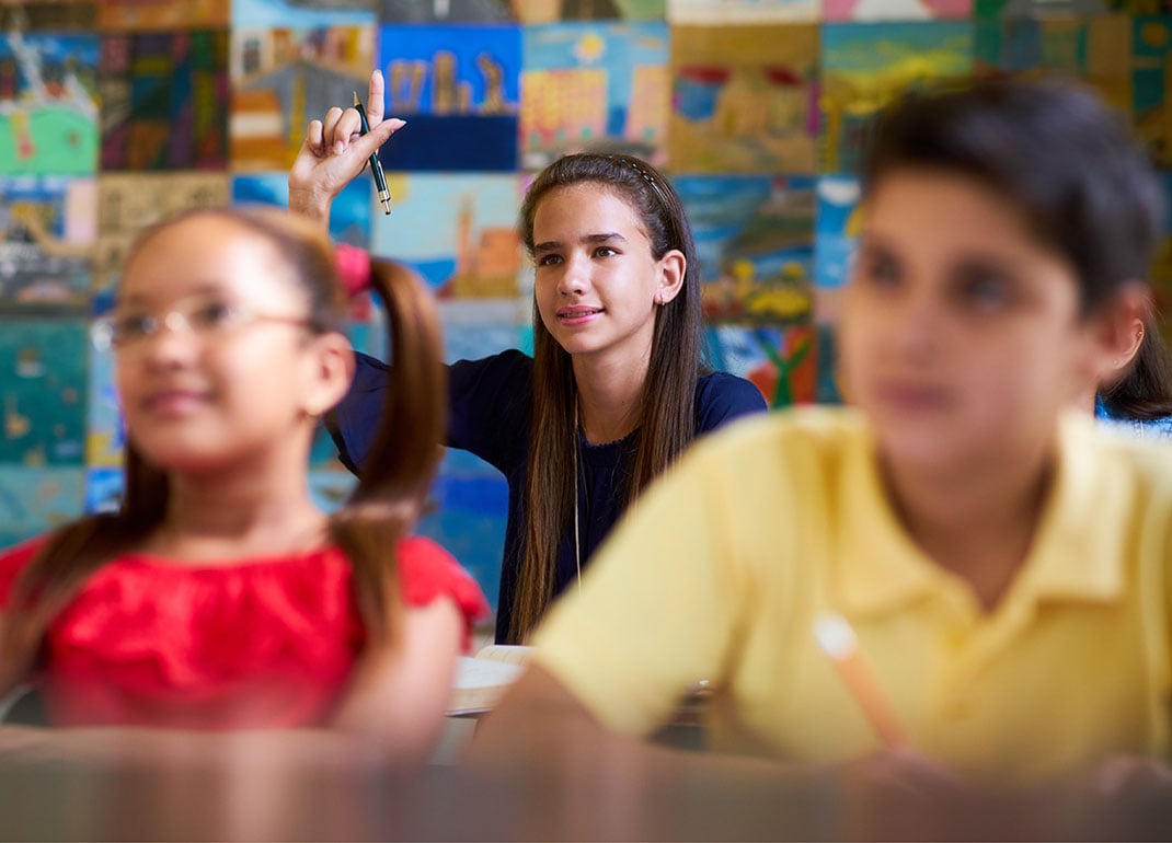 girl-raising-hand-in-class