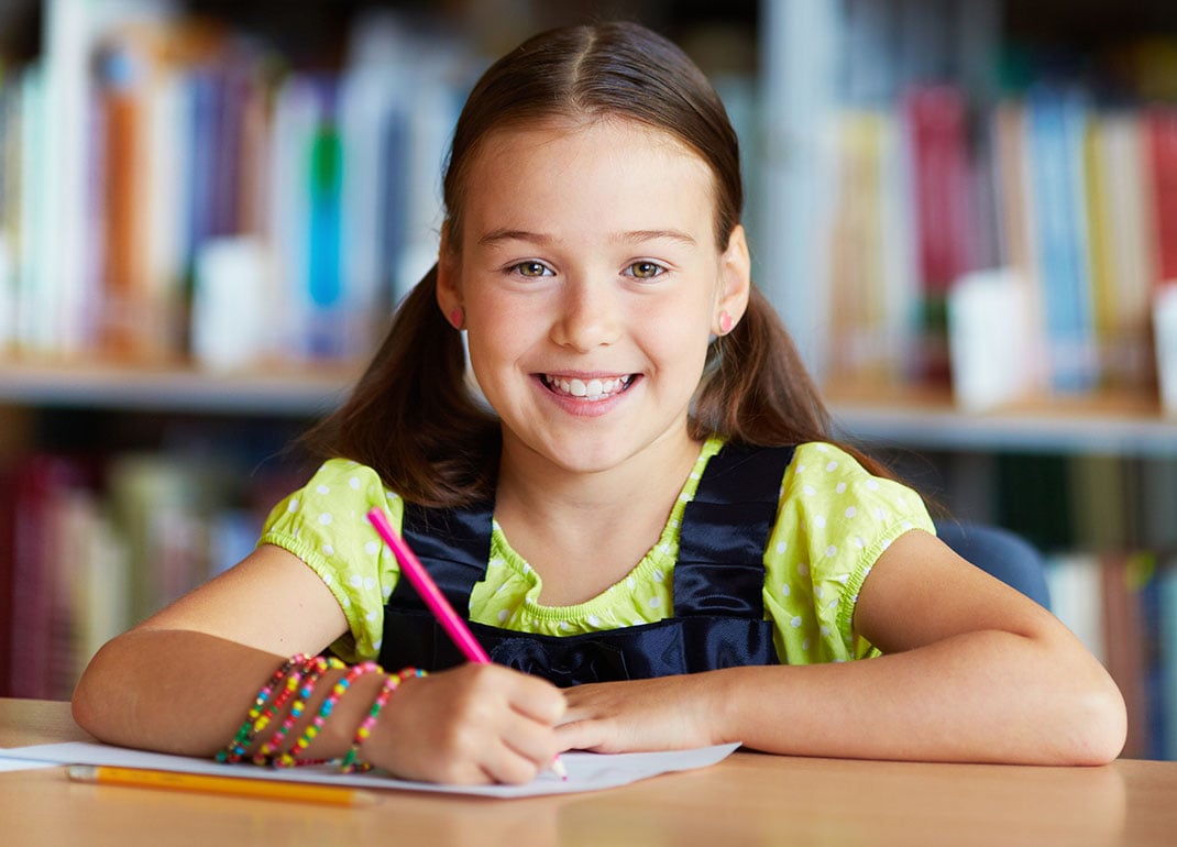 girl-writing-in-library girl-writing-in-library