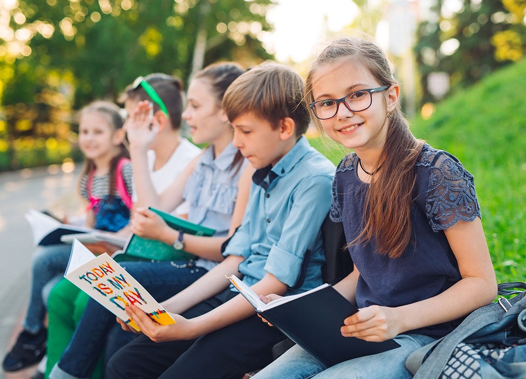 students-outside-on-wall students-outside-on-wall
