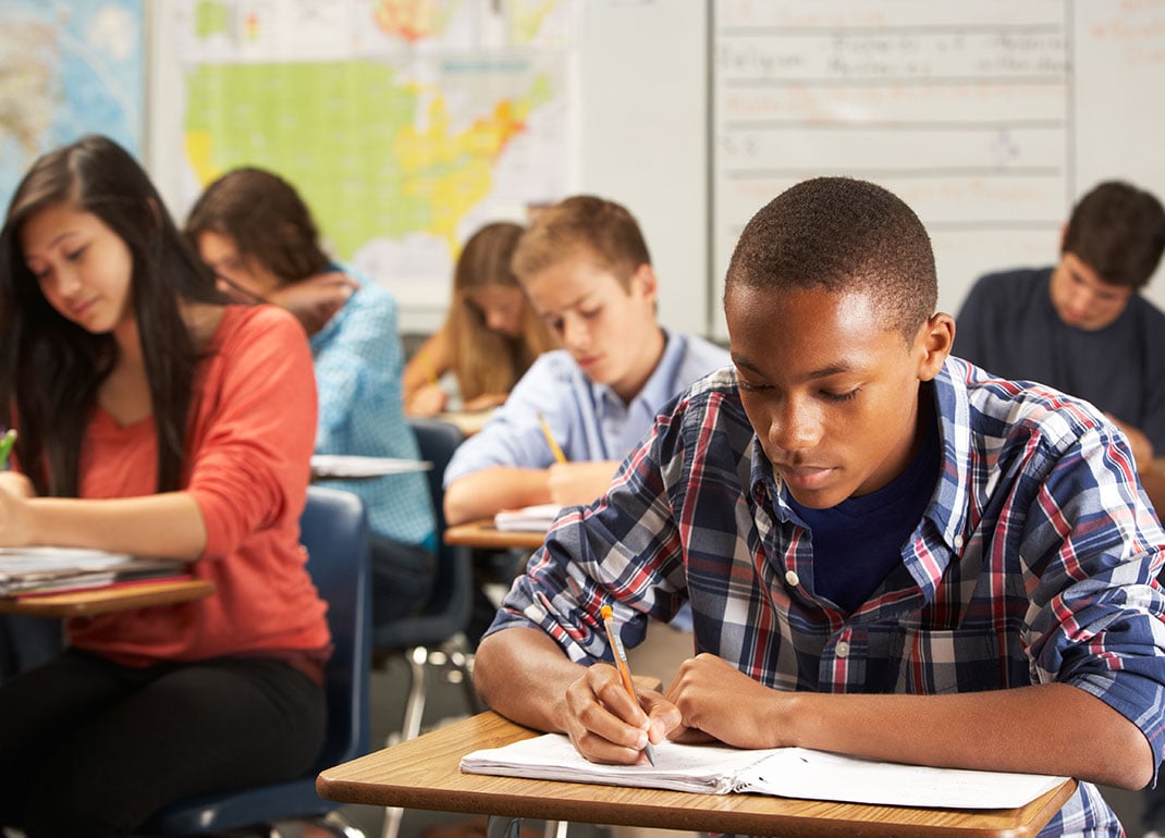 students-working-in-notebooks students-working-in-notebooks